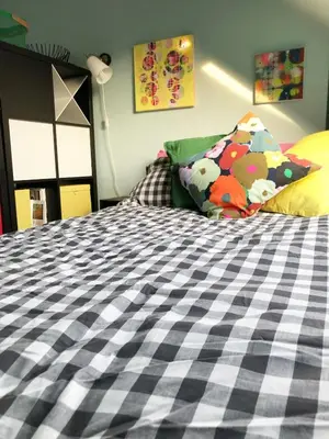a bedroom with a black and white bed with pillows at 'The Artist's Loft' - Studio Flat in Cambridge in Cambridge