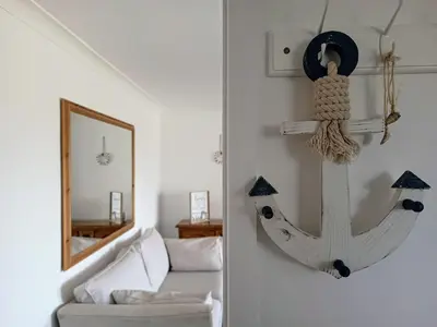 a living room with an anchor hanging on the wall at Bungalow with a view in Kirby Cross