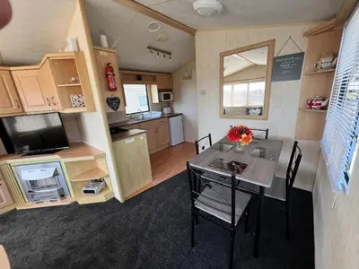 a small kitchen and dining room with a table and chairs at Rohannah A and C Ultimate Retreat in Colchester