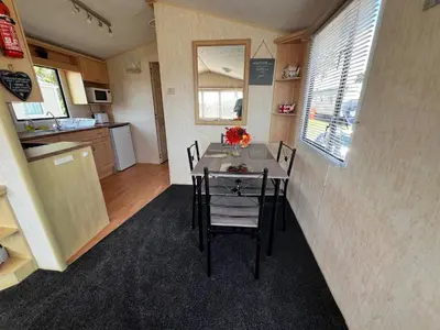 a kitchen and dining room with a table and chairs at Rohannah A and C Ultimate Retreat in Colchester