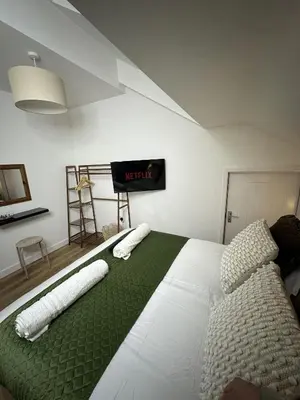 a bedroom with a bed with two pillows on it at Rosern Short Stays in St Ives