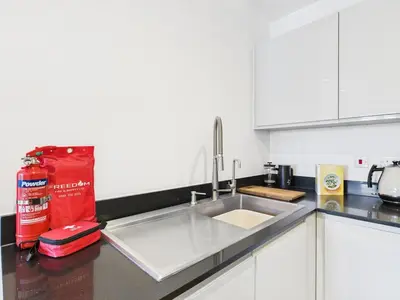 a kitchen with a sink and a counter top at Mid-Long Stay 1 Bedroom Apartment Great Baddow in Great Baddow