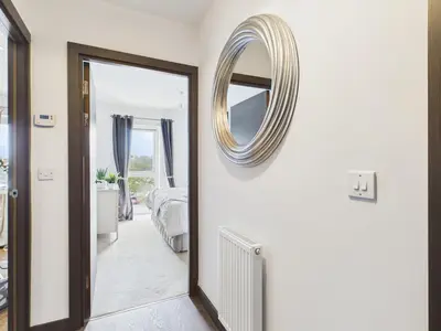 a bedroom with a mirror on the wall and a bed at Mid-Long Stay 1 Bedroom Apartment Great Baddow in Great Baddow