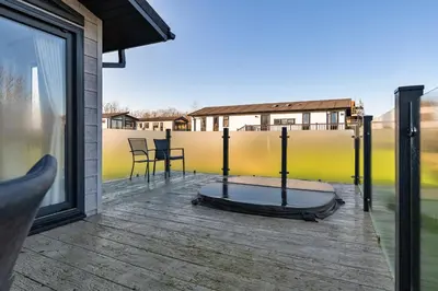 a room with a mattress on a deck at Finest Retreats - Pembroke Luxury Lodge