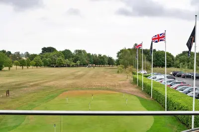 a golf course with flags in a parking lot at Finest Retreats - Pembroke Luxury Lodge
