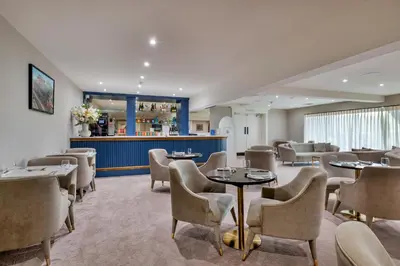 a restaurant with tables and chairs and a bar at Finest Retreats - Churchill Luxury Lodge