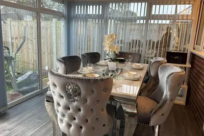 a dining room table with chairs and a table at 4 Bed House - Sleeps 8 - Pets - Parking - Wifi in Great Clacton