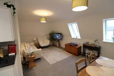 a living room with a couch and a tv at Colchester Roof Top Flat - Central, Business, Travel in Colchester
