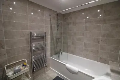 a bathroom with a shower and a tub and a sink at Colchester Roof Top Flat - Central, Business, Travel in Colchester