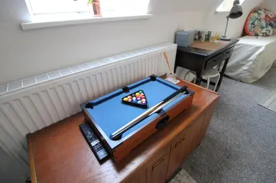 a pool table on a table in a living room at Colchester Roof Top Flat - Central, Business, Travel in Colchester