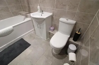 a bathroom with a white toilet and a sink at Colchester Roof Top Flat - Central, Business, Travel in Colchester