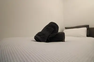 a pair of socks on top of a bed at Colchester Roof Top Flat - Central, Business, Travel in Colchester