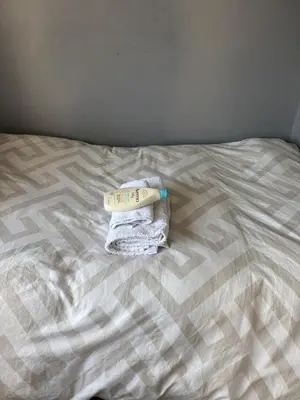 a pile of towels sitting on a bed at Single room in Canvey island in Hadleigh