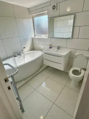 a bathroom with a tub and a toilet and a sink at Detached, 5 Double Bedrooms, 3 En-Suites, 5 Car Parking in Lexden