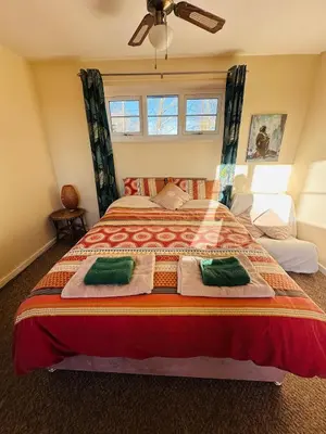 a bedroom with a large bed with towels on it at Family Country Home in Stoke Ferry