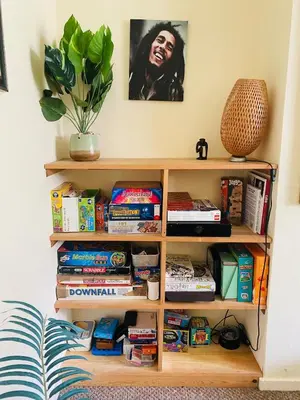 a book shelf filled with food and books at Family Country Home in Stoke Ferry