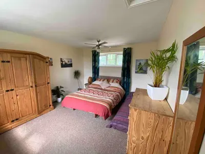a bedroom with a bed and a potted plant at Family Country Home in Stoke Ferry