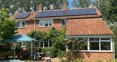 a house with solar panels on the roof at Family Country Home in Stoke Ferry