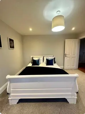 a bedroom with a large white bed in a room at Haggard House Stock in Stock