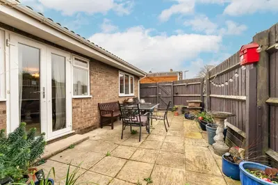 a patio with a table and chairs and a fence at 2-Bed Home with Free Parking - 2 min Walk to Bus in Cherry Hinton