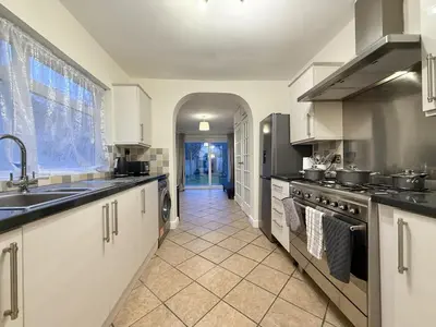 a large kitchen with a sink and a stove at 2 bed house secure parking Sleeps 6 in Ipswich