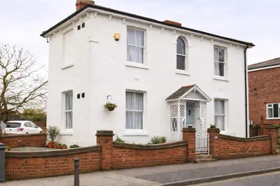 a white house with a brick fence at landvue stays, The Colchester town White House 4 bed 2 bath! in Mundon