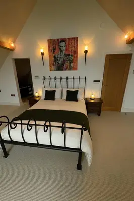 a bedroom with a large bed in a room at Fidlers Moat - Games Room, Gym, Hot Tub