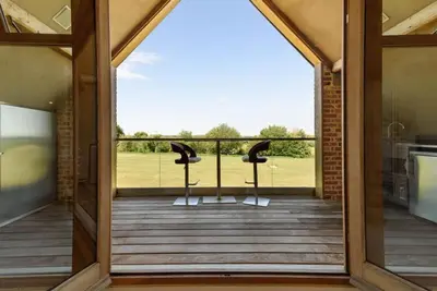 an open door to a porch with two stools at Fidlers Moat - Games Room, Gym, Hot Tub