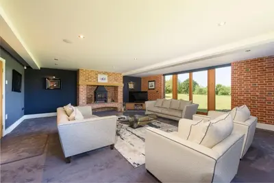 a living room with two couches and a fireplace at Fidlers Moat - Games Room, Gym, Hot Tub
