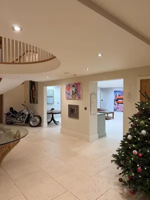 a living room with a christmas tree in the middle at Fidlers Moat - Games Room, Gym, Hot Tub
