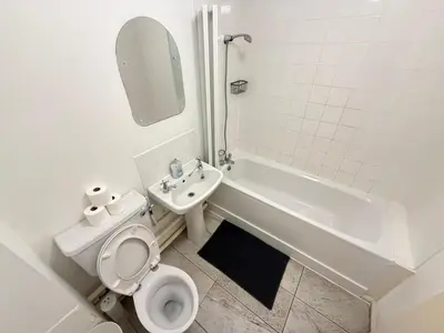 a bathroom with a toilet and a sink and a tub at BMC Serene Spacious 1BR Flat in Enfield