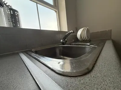 a silver sink in a bathroom with a window at BMC Serene Spacious 1BR Flat in Enfield