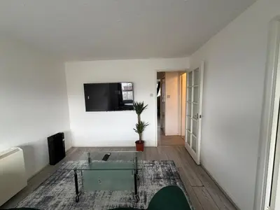 a living room with a glass table and a tv at BMC Serene Spacious 1BR Flat in Enfield