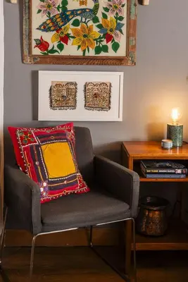a living room with a chair with a pillow on it at 4 Angel Lane in Woodbridge