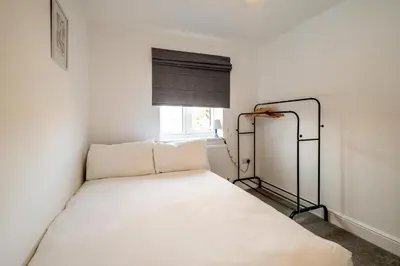 a white bed in a room with a window at Dray Cottage, Leiston, near Sizewell - Ideal for a short or long term corporate lets - Managed by Aldeburgh Coastal Cottages in Leiston