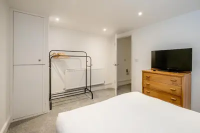 a bedroom with a bed and a television on a dresser at 1 Volunteer House, Leiston, near Sizewell - Ideal for a short or long term corporate lets - Managed by Aldeburgh Coastal Cottages in Leiston
