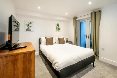 a bedroom with a bed and a television in it at 1 Volunteer House, Leiston, near Sizewell - Ideal for a short or long term corporate lets - Managed by Aldeburgh Coastal Cottages in Leiston