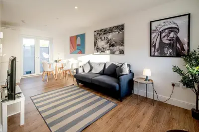 a living room with a couch and a table at Garden Cottage, Leiston, near Sizewell - Ideal for a short or long term corporate lets - Managed by Aldeburgh Coastal Cottages in Leiston