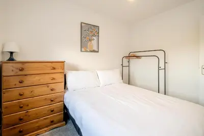 a bedroom with a bed and a dresser at Garden Cottage, Leiston, near Sizewell - Ideal for a short or long term corporate lets - Managed by Aldeburgh Coastal Cottages in Leiston