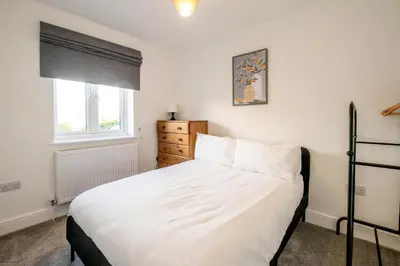 a bedroom with a white bed and a window at Garden Cottage, Leiston, near Sizewell - Ideal for a short or long term corporate lets - Managed by Aldeburgh Coastal Cottages in Leiston