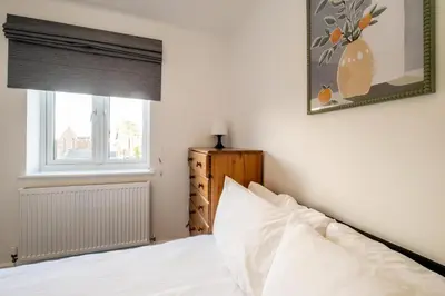 a bedroom with a white bed and a window at Garden Cottage, Leiston, near Sizewell - Ideal for a short or long term corporate lets - Managed by Aldeburgh Coastal Cottages in Leiston