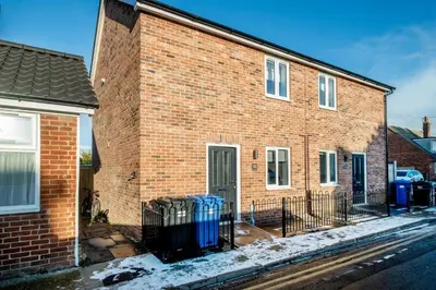 a brick building with blue trash cans in front of it at Garden Cottage, Leiston, near Sizewell - Ideal for a short or long term corporate lets - Managed by Aldeburgh Coastal Cottages in Leiston