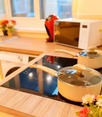 a pot sitting on top of a stove in a kitchen at 3 bed house, sleeps 5, 8 mins to Harold wood Station in Havering atte Bower
