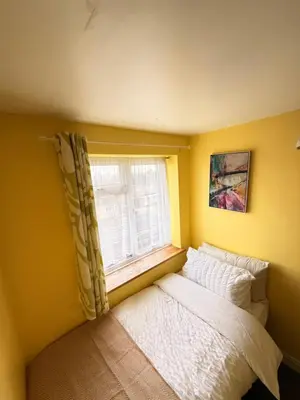 a small bedroom with a bed and a window at 3 bed house, sleeps 5, 8 mins to Harold wood Station in Havering atte Bower