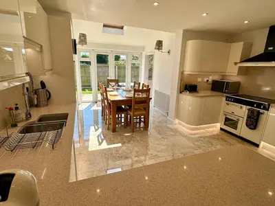 a kitchen with a table and a dining room at Detached, 4 Double Rooms, 2 En-Suites, 5 Car Parking in Lexden