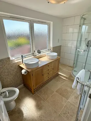 a bathroom with two sinks and a shower and a toilet at Detached, 4 Double Rooms, 2 En-Suites, 5 Car Parking in Lexden