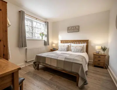 a bedroom with a bed and a window at Greenacres in Kelsale