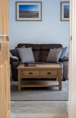 a living room with a couch and a coffee table at Greenacres in Kelsale