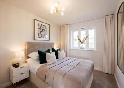 a bedroom with a large bed and a window at Margrets Crescent in Leiston