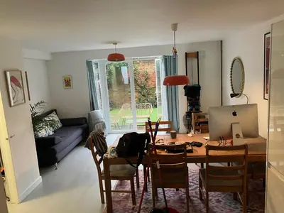 a living room with a table and chairs and a couch at 4 De Vere Lane, Wivenhoe in Wivenhoe